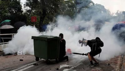 Handful of Hong Kong protesters surrender as university siege staggers on