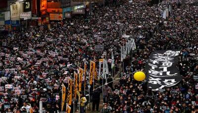 Tear gas fired at Hong Kong new year's mass march as protesters vow to 'keep fighting'