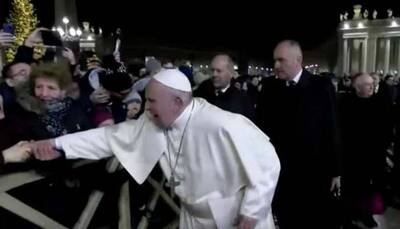Pope Francis apologises for 'bad example' of slapping arm of pilgrim who tugged him