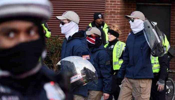 Masked white nationalists march in Washington with police escort