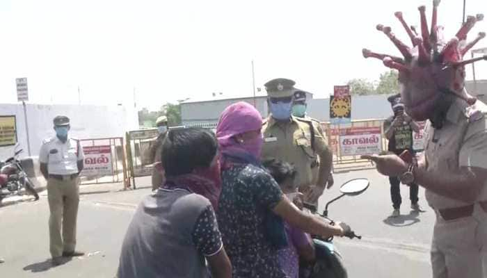 Policeman wears helmet designed like coronavirus to raise awareness about lockdown in Chennai