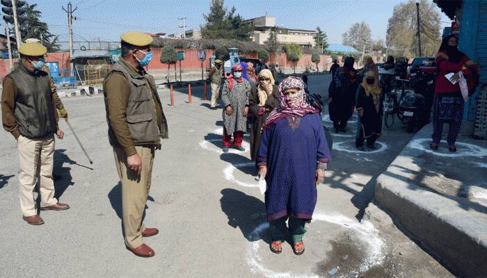 Jammu and Kashmir authorities distribute masks among rural people to combat COVID-19