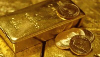 Gold falls on firm dollar, US economy re-open hopes
