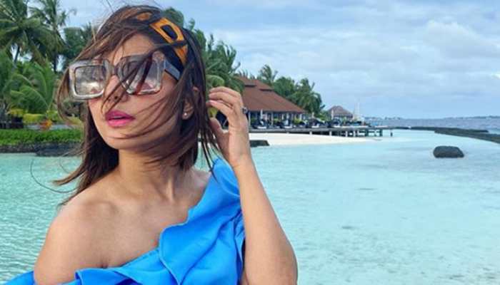 Hina Khan raises the hotness bar in a chic pantsuit flaunting washboard abs and we can't stop drooling over the pic!