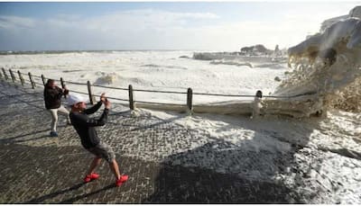Cape Town promenade witnesses stormy sea foam; attracts, drenches onlookers