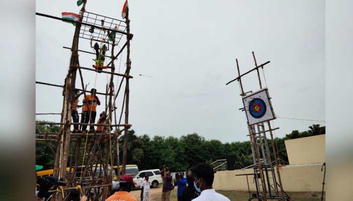 Suspended upside-down at 20 feet height, 5-year old performs daring archery feat