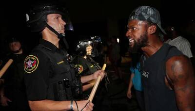Black man shot in back by police in Wisconsin city, says governor; curfew imposed