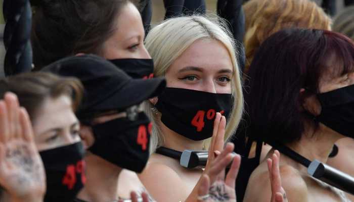 Bare-chested women lock themselves to UK parliament in climate protest