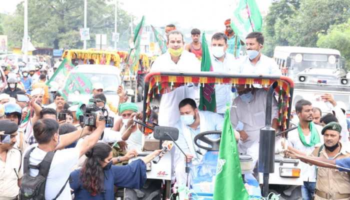 RJD leader Tejashwi Yadav drives tractor, brother Tej Pratap Yadav sits atop it during protest over Farm Bills: Watch
