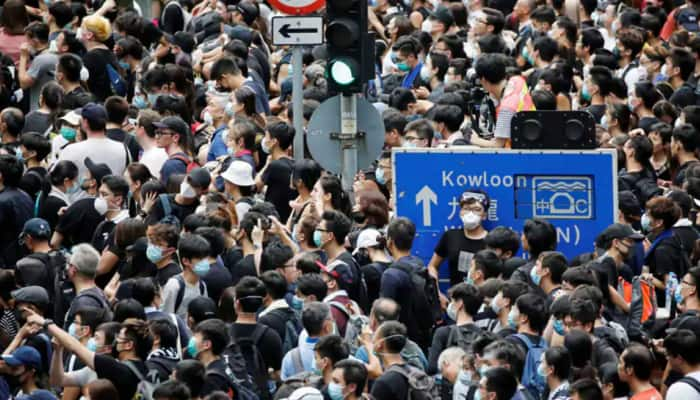 Hong Kong leader says stability restored, riot police on alert over banned protest march