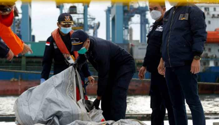 Indonesia finds body parts, debris, detects emergency signal of crashed jet