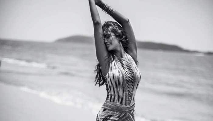 Esha Gupta flaunts perfect hourglass figure as she poses on the beach