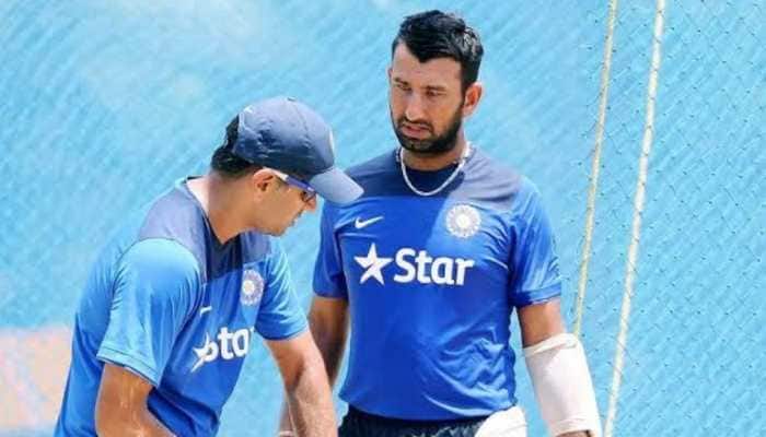 Cheteshwar Pujara (right) takes some tips from Rahul Dravid (left) in the nets. (Source: Twitter)
