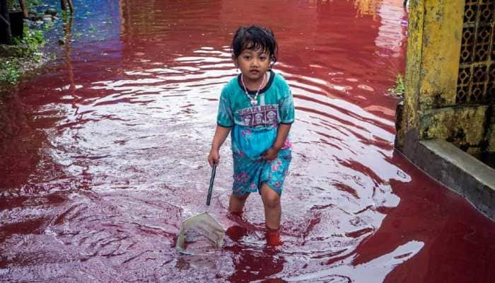 Indonesian village turns red as floods hit batik factory- See pic