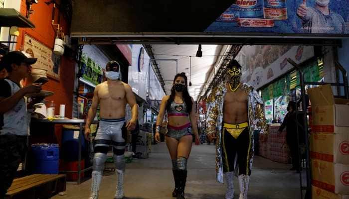 Put on a mask: Lucha libre wrestlers promote COVID-19 safety in busy Mexico markets