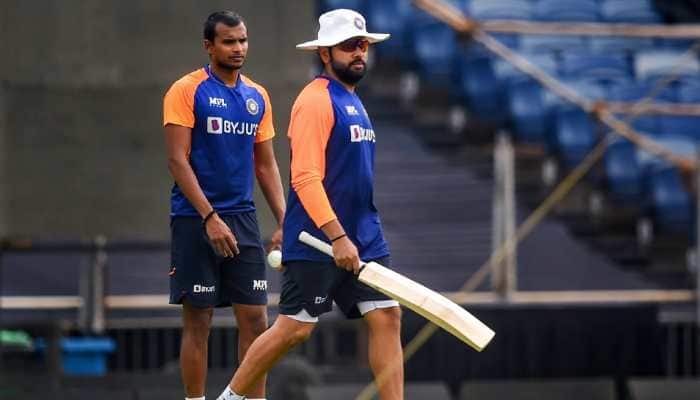 Indian opener Rohit Sharma at a training session with paceman T. Natarajan (left) ahead of the first ODI against England in Pune. (Photo: PTI)
