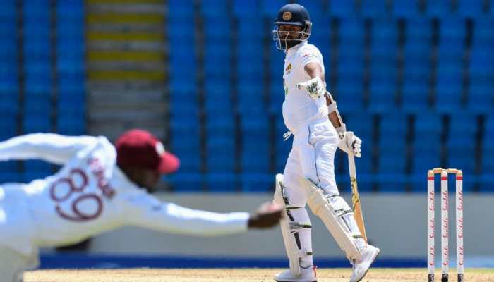 West Indies' Nkrumah Bonner takes a diving catch of Sri Lanka captain Dimuth Karunaratne on Day Two of second Test in Antigua. (Photo: Cricket West Indies)