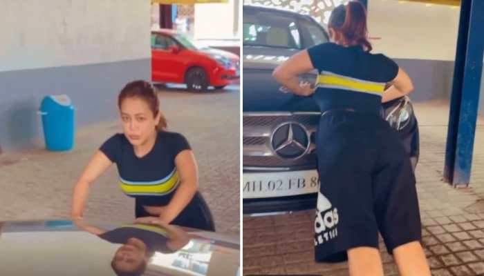 Neha Kakkar turns her parking lot into gym, does push-ups on her Mercedes! - WATCH