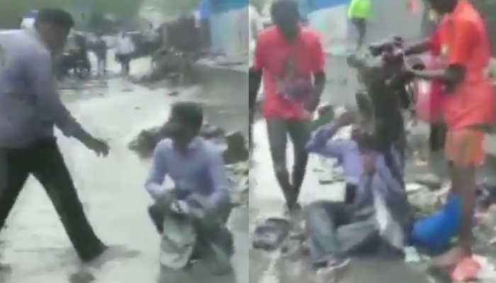 Mumbai rains: Shiv Sena MLA makes contractor sit on waterlogged road, asks workers to dump garbage on him - Watch