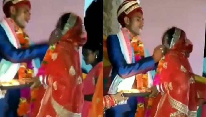 Viral video: Dulha force feeds &#039;ladoo&#039; to bride, appalled netizens call it &#039;abuse’