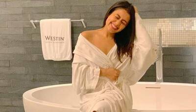 Neha Kakkar teases pics in a white bathrobe, hubby Rohanpreet Singh goes 'ahem ahem'!