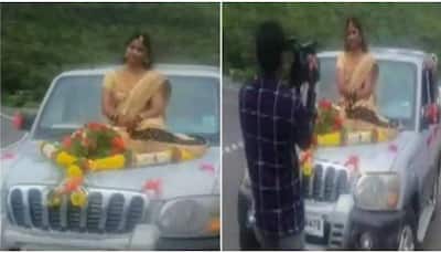 Bride booked for not wearing mask as she poses on top of a moving car - Video goes viral