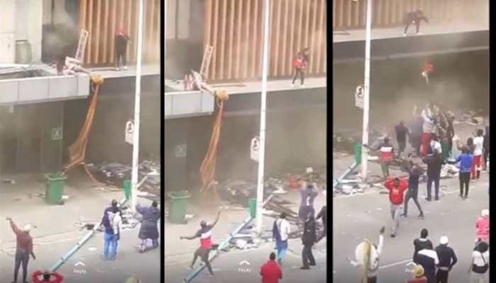 South African mother throws 2-year-old child from burning building amid riots