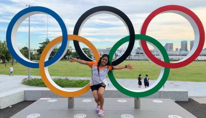 Indian gymnast Pranati Nayak poses in front of the Olympic rings in the Athletes Village in Tokyo. (Source: Twitter)