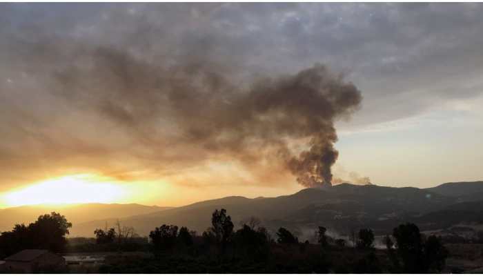Thousands forced to flee as California wildfires turn dozens of homes into ashes