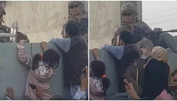 Desperate Afghan women throw babies over razor wire at Kabul airport compound, UK soldiers cry