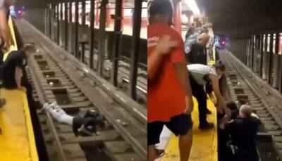 US cop, commuter scramble to save man who fell on subway tracks - Watch hair raising video