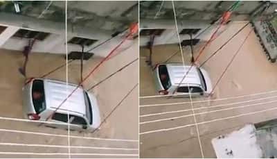 Desi jugaad! Car tied with rope to prevent from being washed away in flood water, video goes viral 