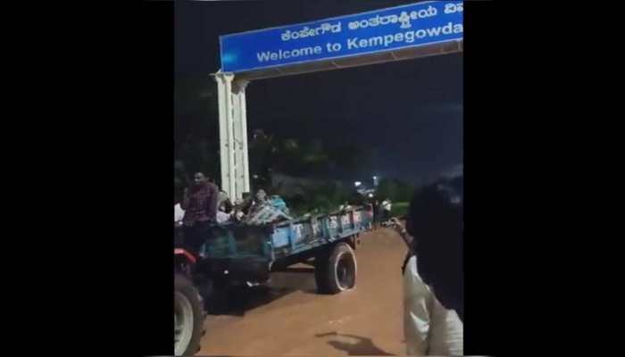 Passengers ferried on tractor to catch flight as heavy rains flood karnataka Kempe Gowda airport - Watch 