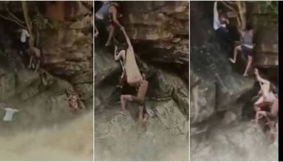 Tamil Nadu forest officials brave raging waterfall to rescue trapped woman and infant - WATCH