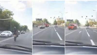 Viral video: Stunt goes horribly wrong, biker crashes into tanker while performing wheelie - Watch