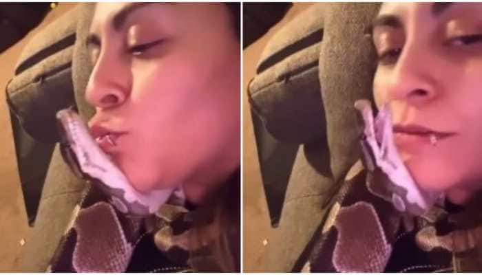 Bizarre! Woman cuddles with pet snake, leaves internet amazed- Watch