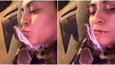 Bizarre! Woman cuddles with pet snake, leaves internet amazed- Watch