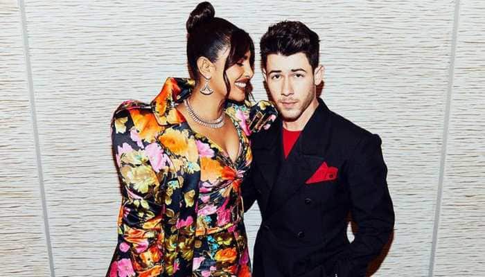Nick Jonas fixes Priyanka Chopra&#039;s trailing floral coat at red carpet, fans shout &#039;such a gentleman!&#039; - Watch