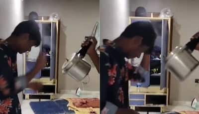 Desi jugaad: Man uses steam from pressure cooker to dry hair! Watch viral video
