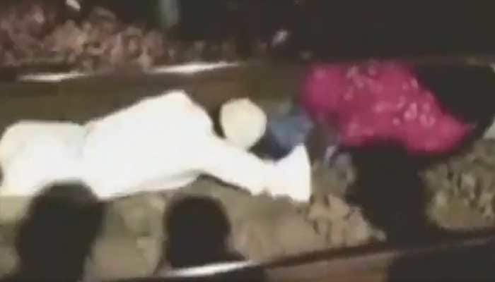 Watch: Man jumps under moving train to rescue a woman in Madhya Pradesh 