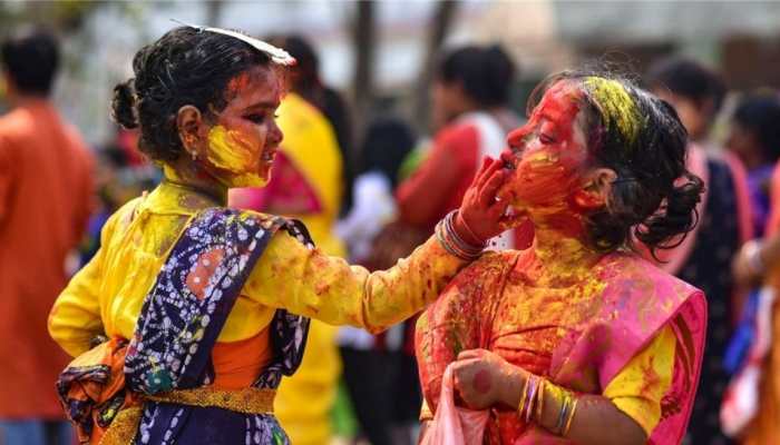 With colours, flowers and prayers; India rings in Holi - WATCH