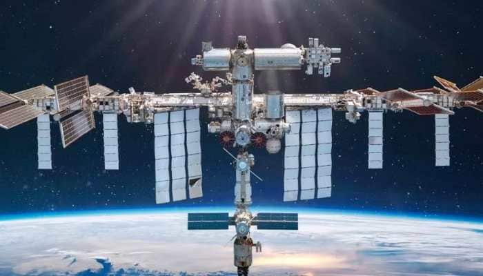 Russian cosmonauts arrive at International space station in yellow and blue