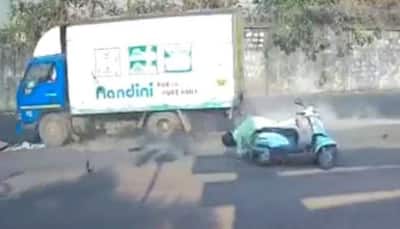 Watch: Woman riding scooter gets hit by truck, helmet saves life