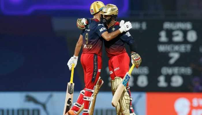 RCB batter Dinesh Karthik hugs teammate Harshal Patel after the win over KKR in their IPL 2022 match. Karthik became the second wicketkeeper to play 200 IPL matches as a wicketkeeper. MS Dhoni is on top, featuring in 215 games. (Source: Twitter)