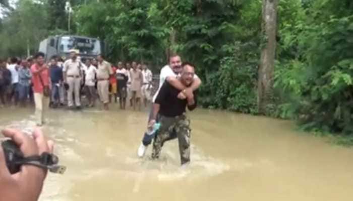 Assam BJP MLA takes piggyback ride on rescue worker while assessing flood situation - Watch