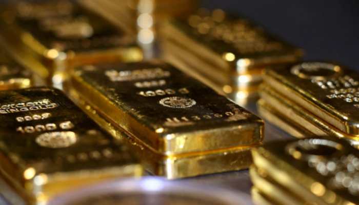 Gold prices rise in range-bound trade as dollar dips
