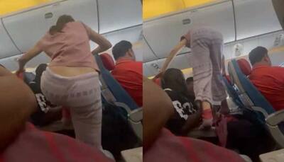 Woman hops over passengers to get to her window seat on plane: Watch video