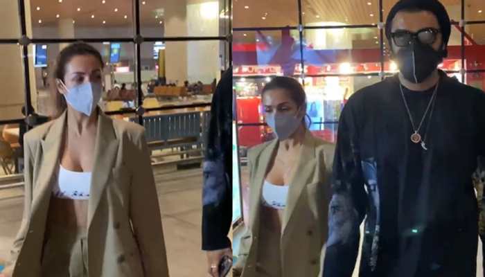 Malaika Arora BRUTALLY trolled for wearing oversized jacket with a bustier top at airport, haters ask 'is it snowing in Mumbai?'