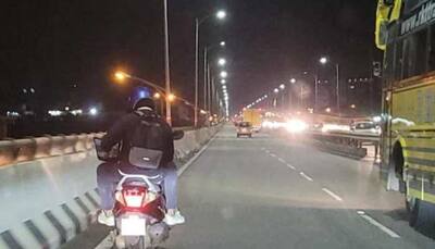 Image of Bengaluru man working on laptop while riding pillion goes viral, netizens react