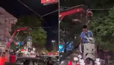 Viral video: Traffic police crane lifts scooter with owner still sitting on it - WATCH
